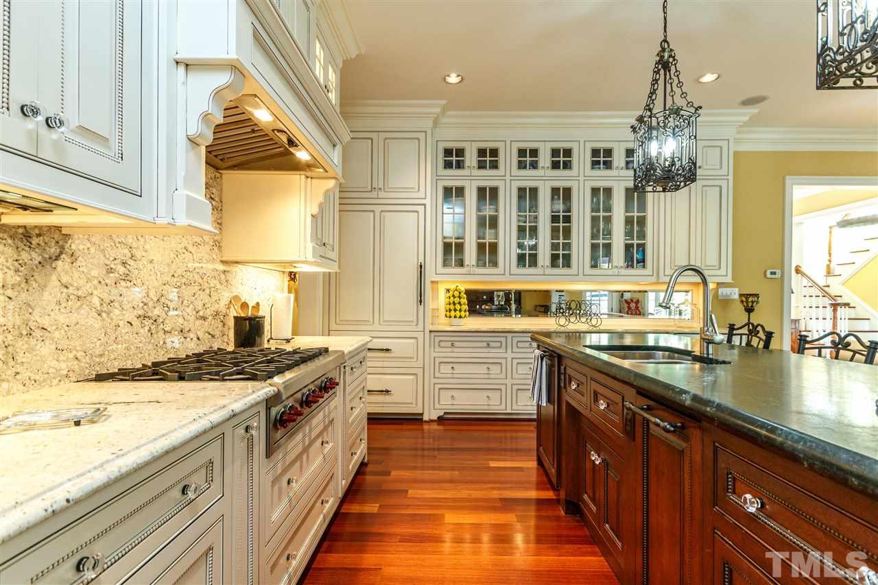 3721 Rolston Drive Raleigh, NC 27609 - Photo 9 of 30 a large kitchen with stainless steel appliances granite countertop a stove and a sink