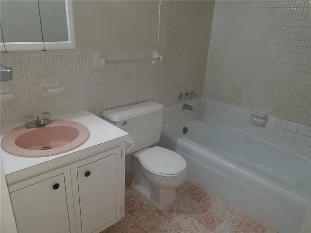 a bathroom with a toilet and a bath tub