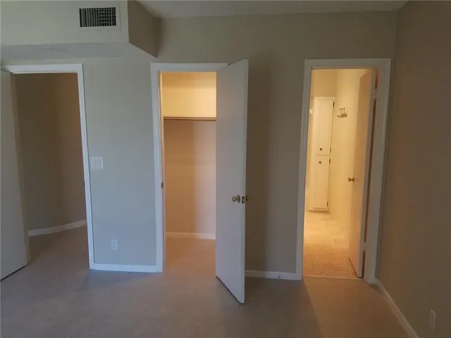 an empty room with an empty space and closet