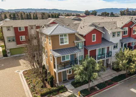 an aerial view of a residential apartment building with a yard
