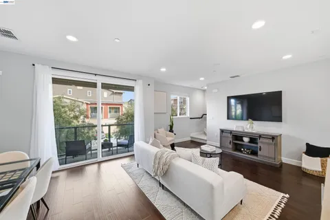 a living room with furniture and view of kitchen