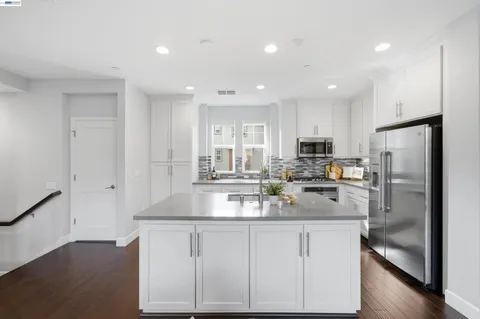 a kitchen with a sink and refrigerator
