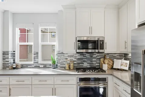 a kitchen with a sink stove and refrigerator