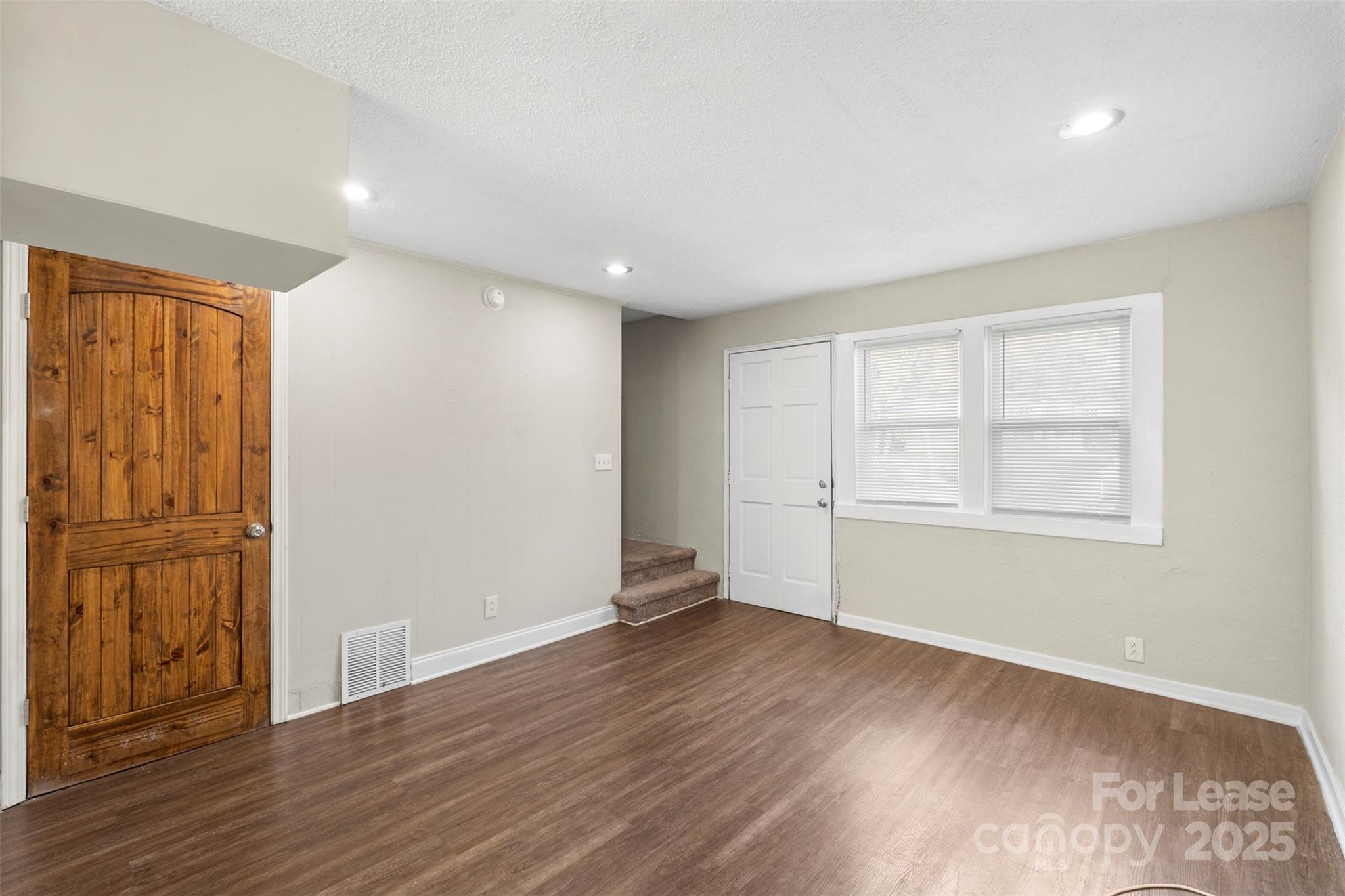 2405 Julia Avenue, Unit 1 Charlotte, NC 28206 - Photo 14 of 15 an empty room with wooden floor and windows