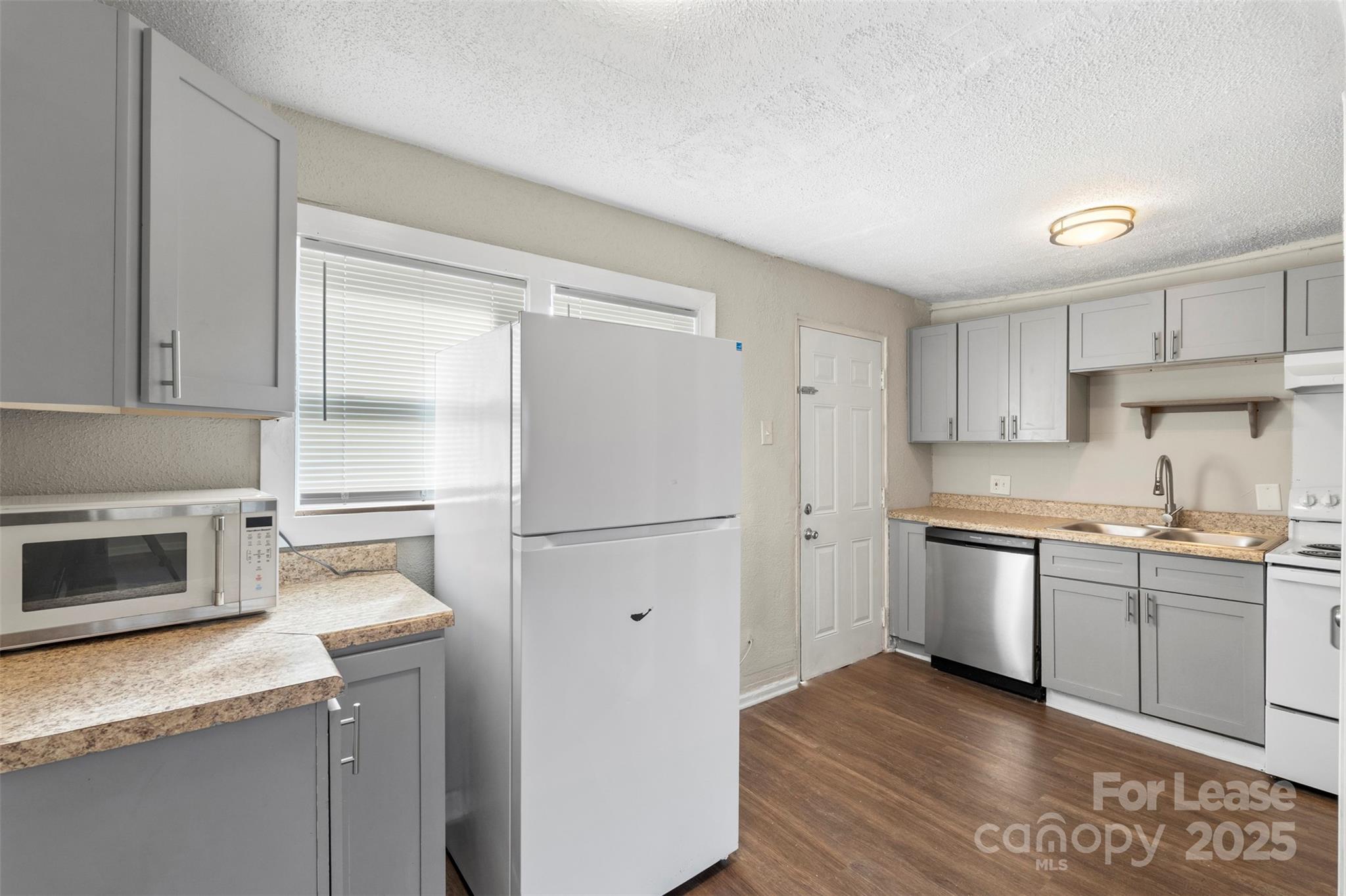 2405 Julia Avenue, Unit 1 Charlotte, NC 28206 - Photo 4 of 15 a kitchen with a sink and a refrigerator