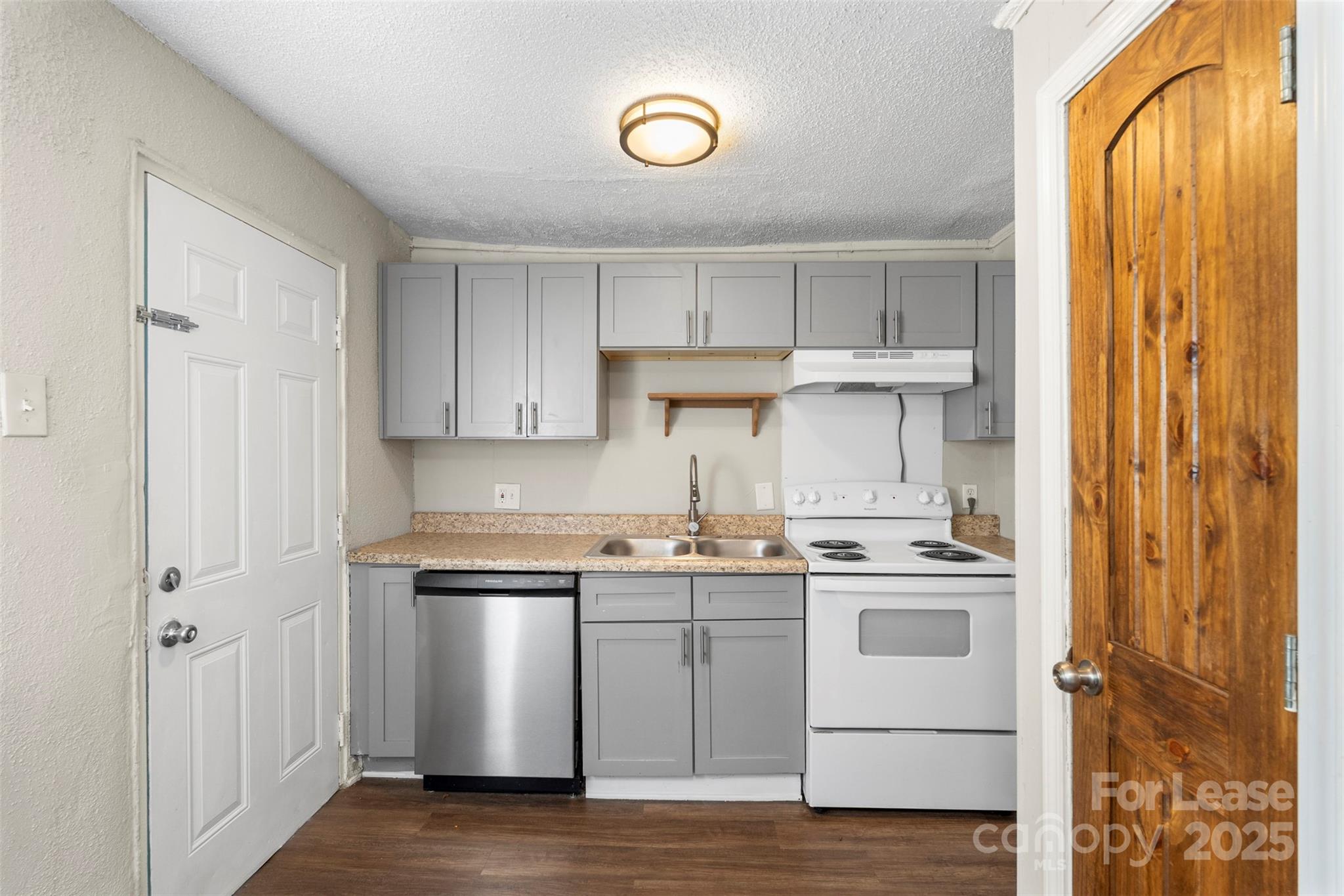 2405 Julia Avenue, Unit 1 Charlotte, NC 28206 - Photo 5 of 15 a kitchen with stainless steel appliances granite countertop a sink and cabinets with wooden floor