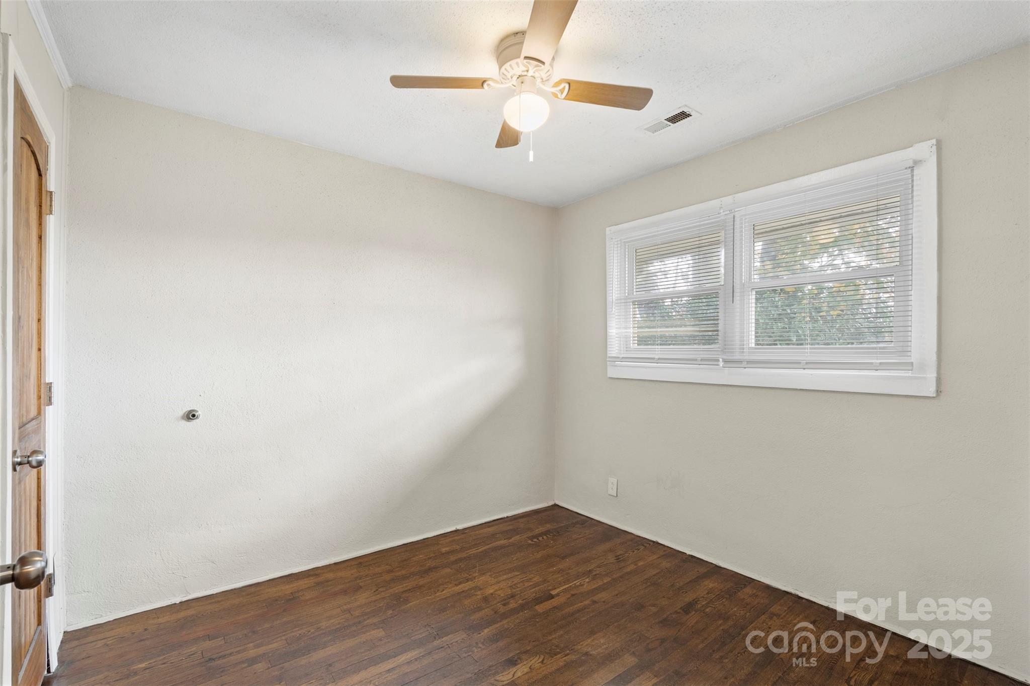 2405 Julia Avenue, Unit 1 Charlotte, NC 28206 - Photo 8 of 15 a view of an empty room with a window and wooden floor