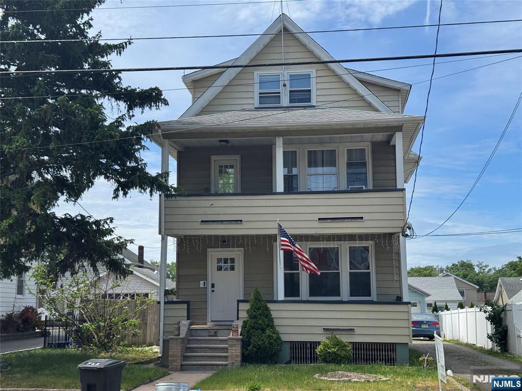 138 Carlton Avenue East Rutherford, NJ 07073 - Photo 1 of 14 a front view of a house with garden