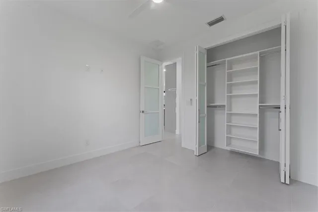 a view of an empty room and closet area
