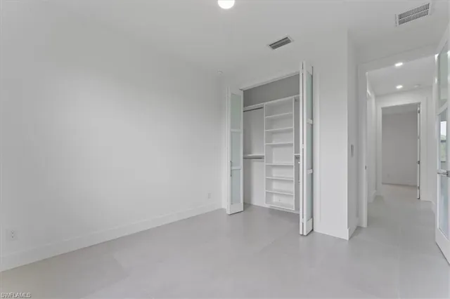 a view of an empty room and a hallway