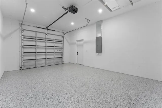 an empty room with a ceiling fan and window