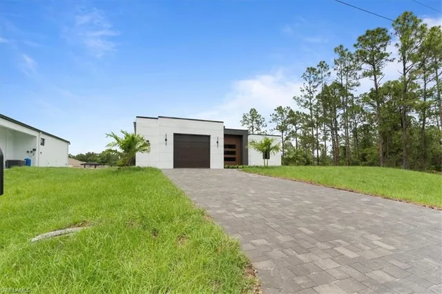a front view of house with yard and green space