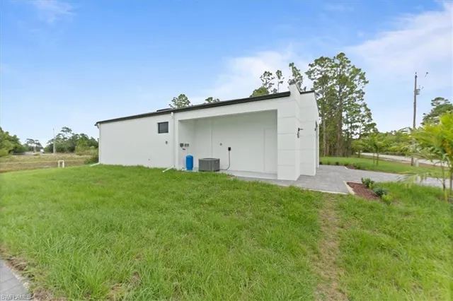 a view of a white house with a yard