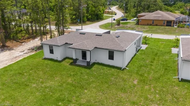 a aerial view of a house with backyard and pool
