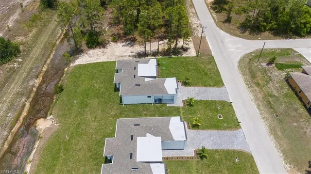 an aerial view of a house with a garden and swimming pool