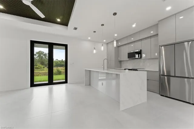 a view of a kitchen with a sink and a refrigerator