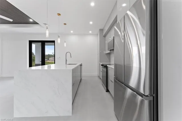 a kitchen with refrigerator a washer and dryer