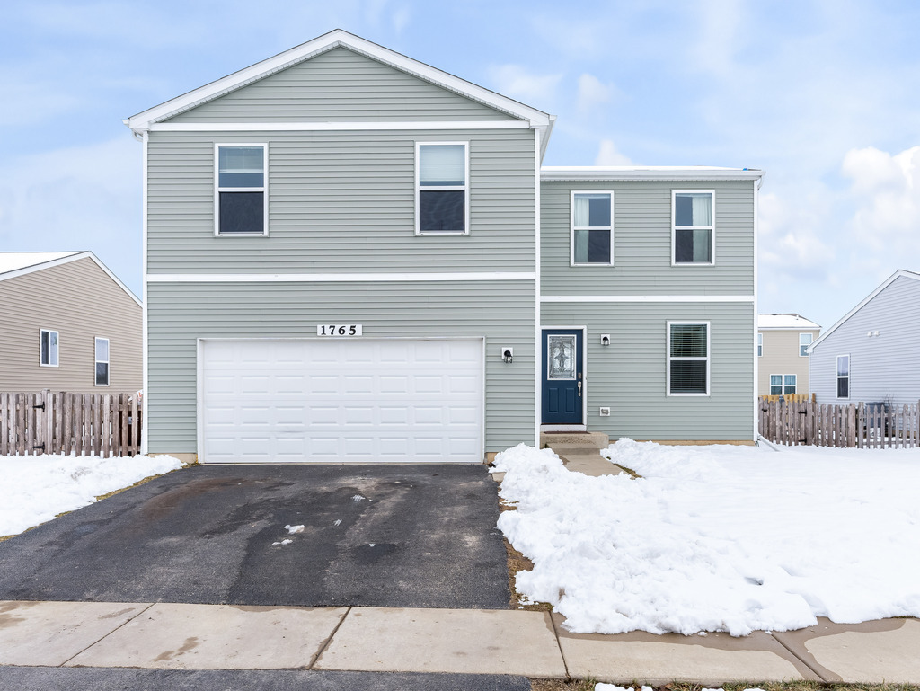 1765 Sebastian Road Woodstock, IL 60098 - Photo 1 of 25 a front view of a house with a outdoor space
