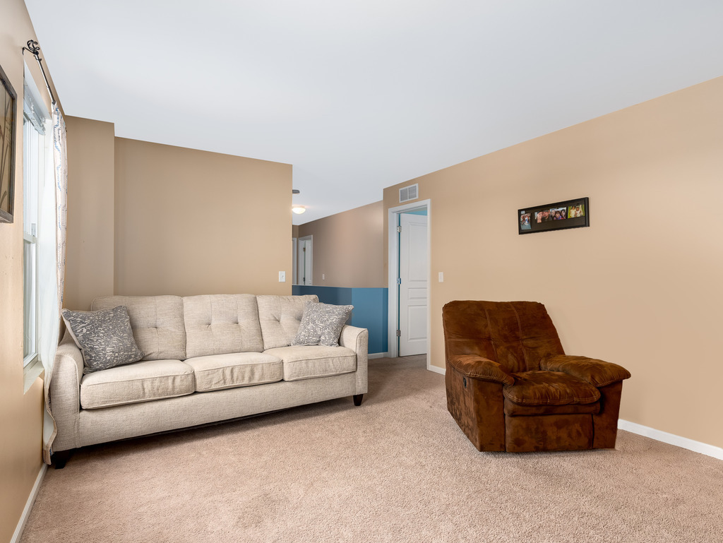 1765 Sebastian Road Woodstock, IL 60098 - Photo 12 of 25 a living room with furniture and a couch