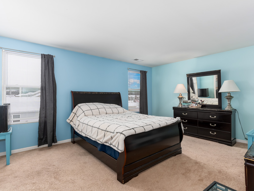 1765 Sebastian Road Woodstock, IL 60098 - Photo 13 of 25 a bedroom with a bed and a dresser