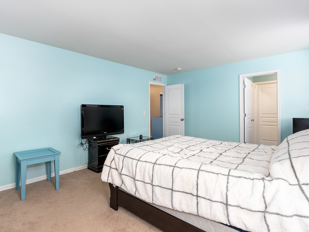 1765 Sebastian Road Woodstock, IL 60098 - Photo 14 of 25 a bedroom with a bed and a flat screen tv