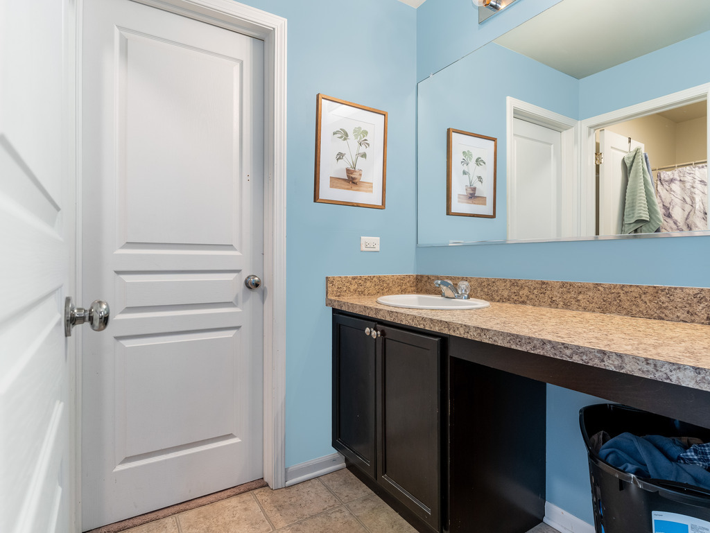 1765 Sebastian Road Woodstock, IL 60098 - Photo 15 of 25 a bathroom with a granite countertop sink and a mirror