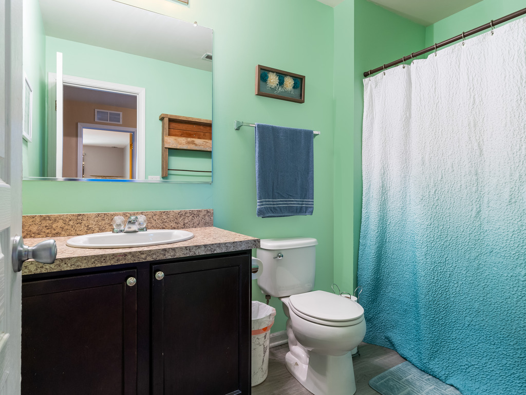 1765 Sebastian Road Woodstock, IL 60098 - Photo 18 of 25 a bathroom with a granite countertop toilet sink and mirror
