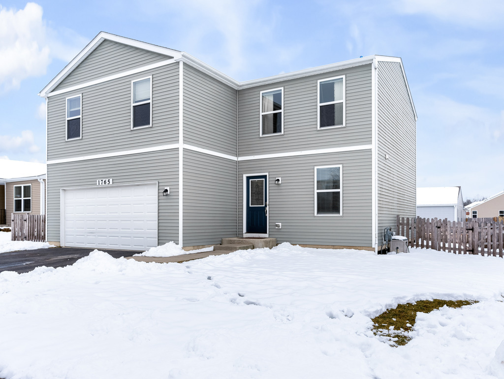 1765 Sebastian Road Woodstock, IL 60098 - Photo 2 of 25 a view of house with yard and covered with snow
