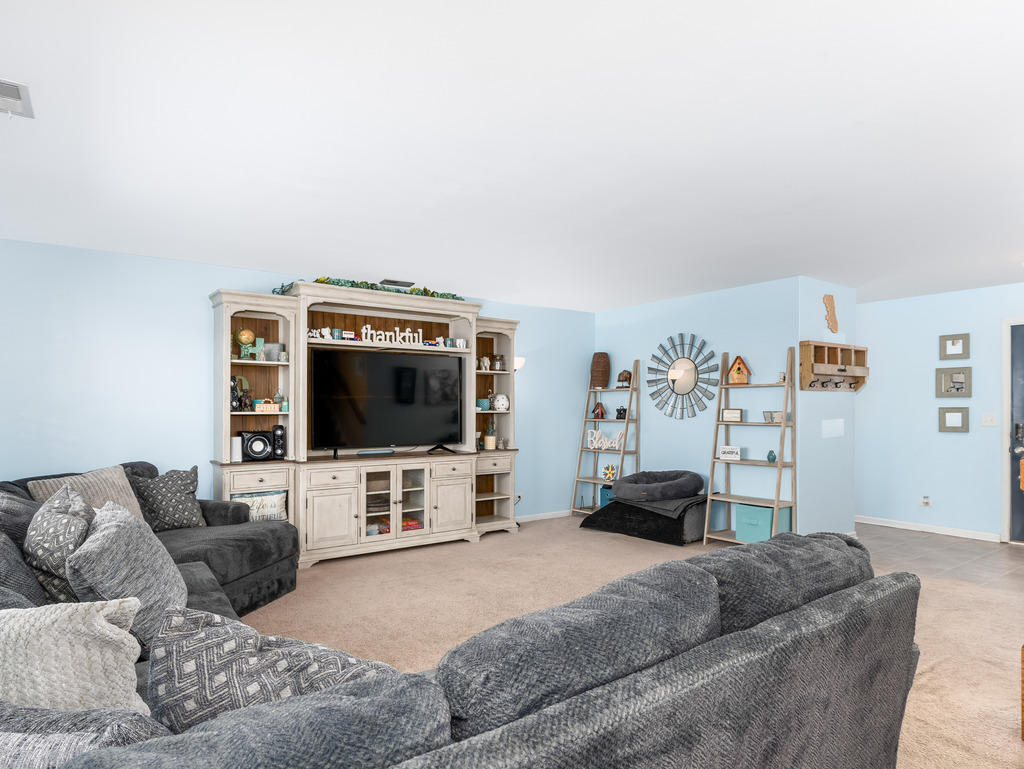1765 Sebastian Road Woodstock, IL 60098 - Photo 3 of 25 a living room with furniture and a flat screen tv