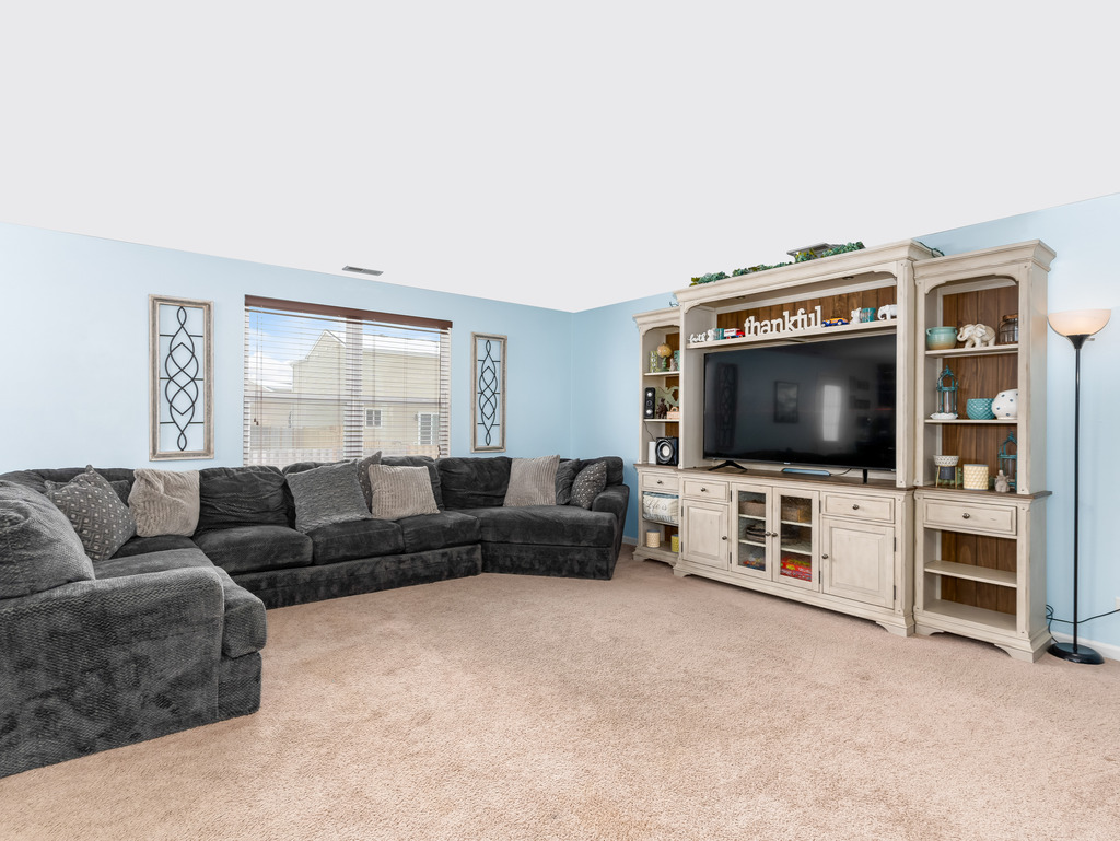 1765 Sebastian Road Woodstock, IL 60098 - Photo 4 of 25 a living room with furniture and a flat screen tv