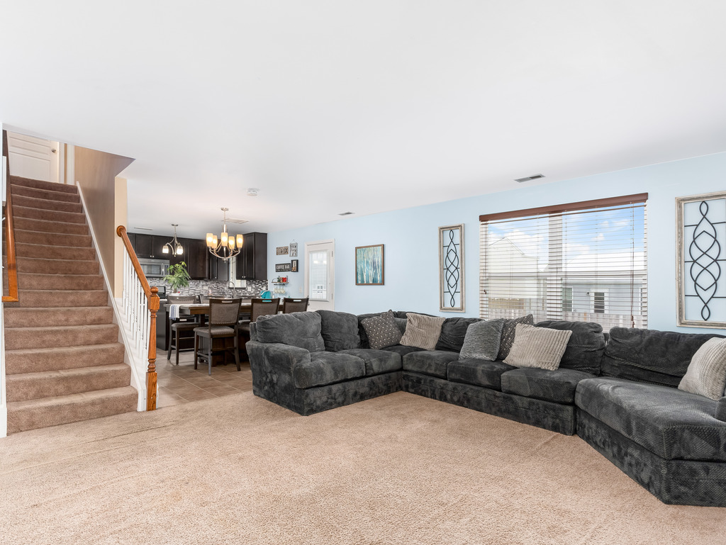 1765 Sebastian Road Woodstock, IL 60098 - Photo 5 of 25 a living room with furniture and a large window