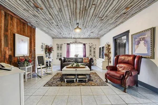 a living room with furniture a flat screen tv and a large window