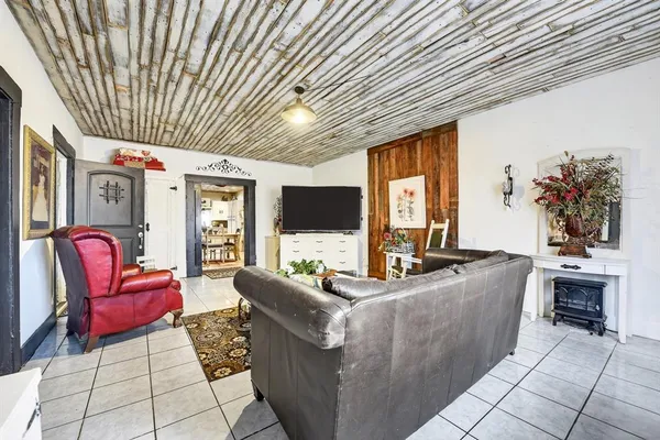a living room with furniture fireplace and flat screen tv