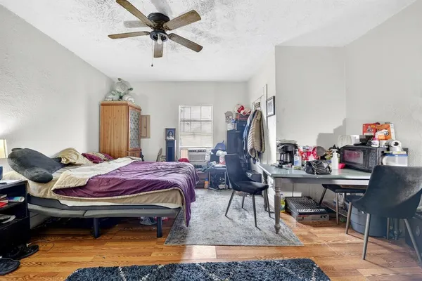 a bedroom with a bed and a chandelier