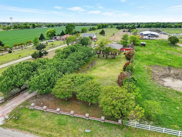 an aerial view of huge green field with lots of green space