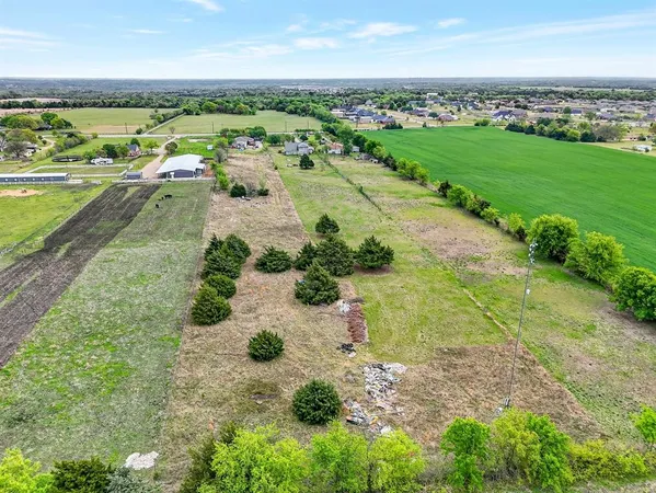 an aerial view of a city with lots of residential buildings and mountain view in back