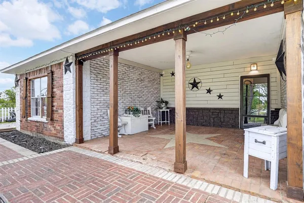 a porch with a table and chairs