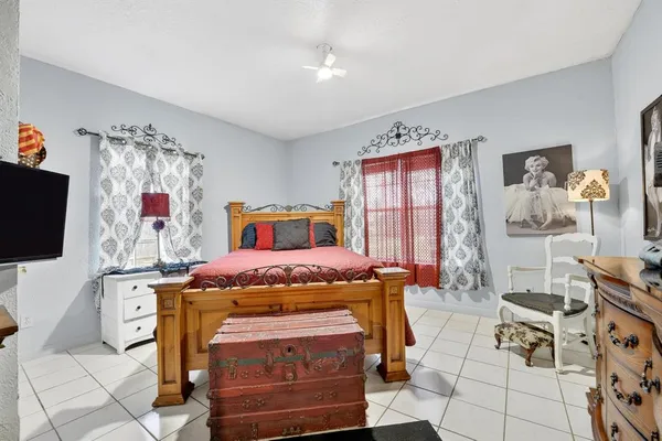 a bedroom with furniture and flat screen tv