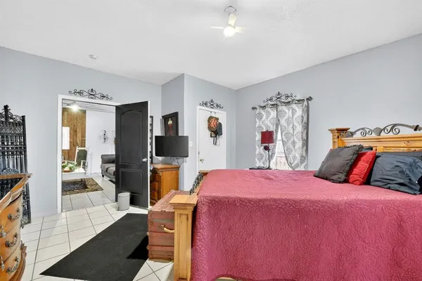 a bedroom with a bed and a flat screen tv