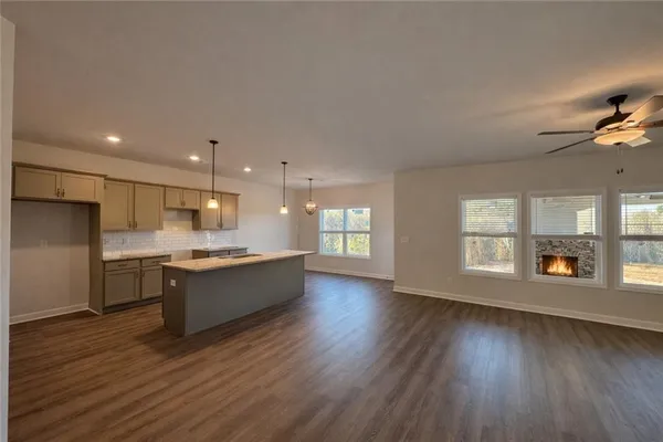 a large kitchen with a wooden floor and a large window