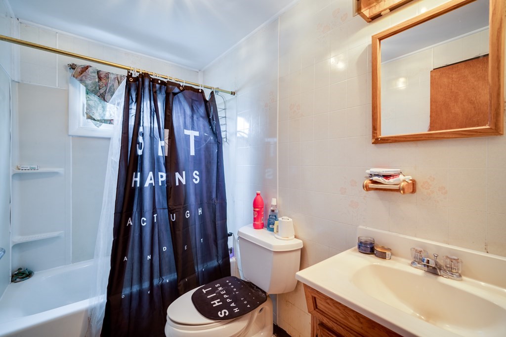 109 Middle Street Springfield, MA 01104 - Photo 12 of 14 a bathroom with a sink and a mirror