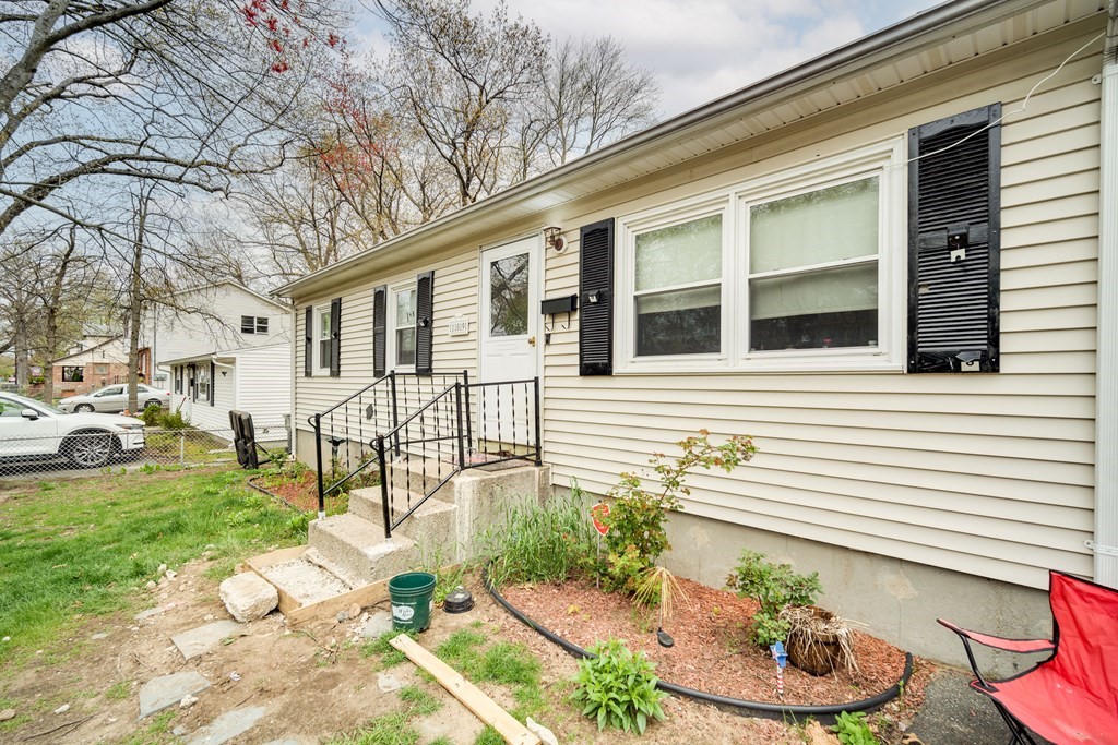 109 Middle Street Springfield, MA 01104 - Photo 2 of 14 a front view of a house with backyard and chairs