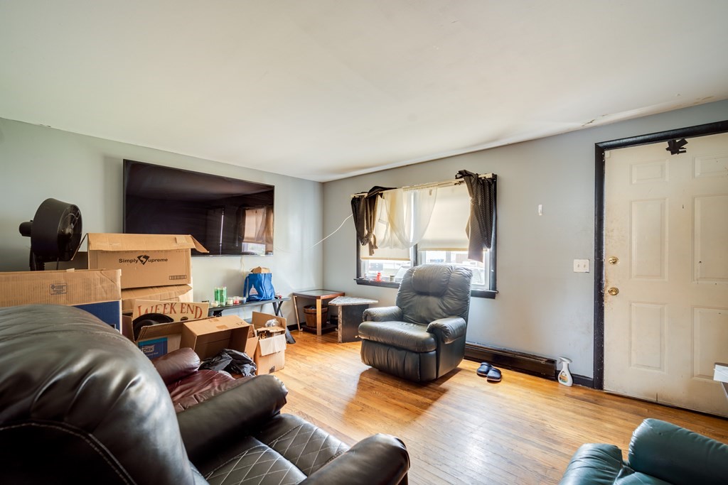 109 Middle Street Springfield, MA 01104 - Photo 4 of 14 a living room with furniture and a wooden floor