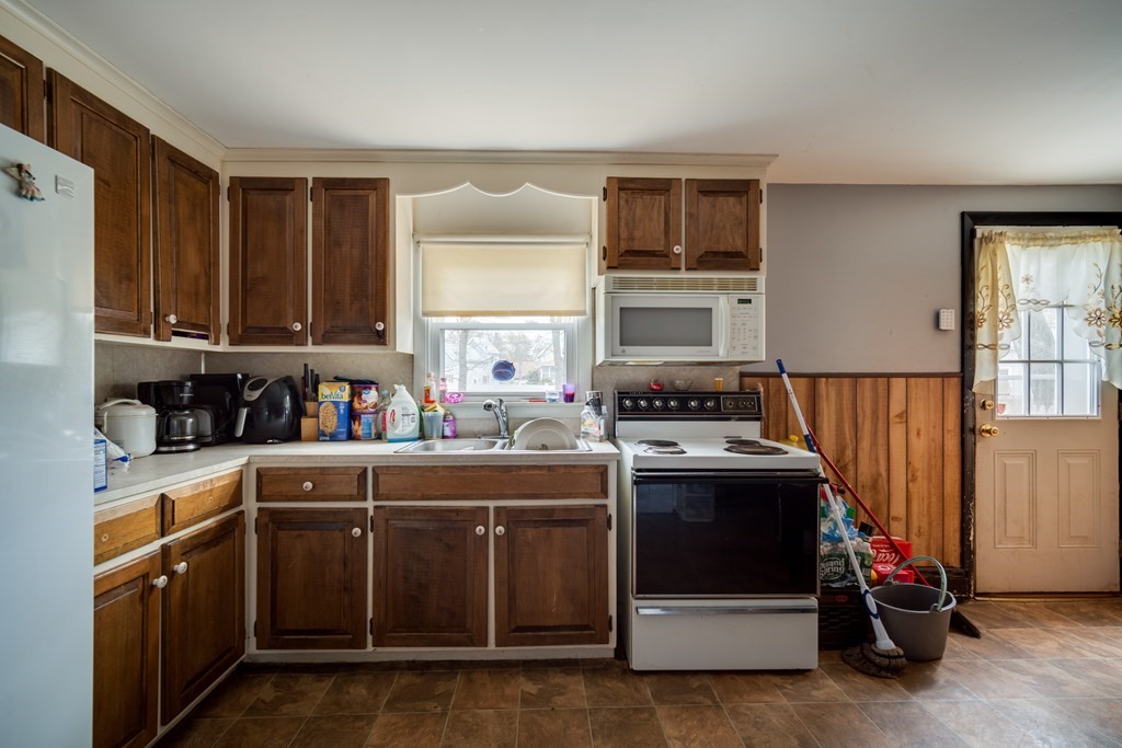109 Middle Street Springfield, MA 01104 - Photo 6 of 14 a kitchen with stainless steel appliances granite countertop a stove a sink and a refrigerator