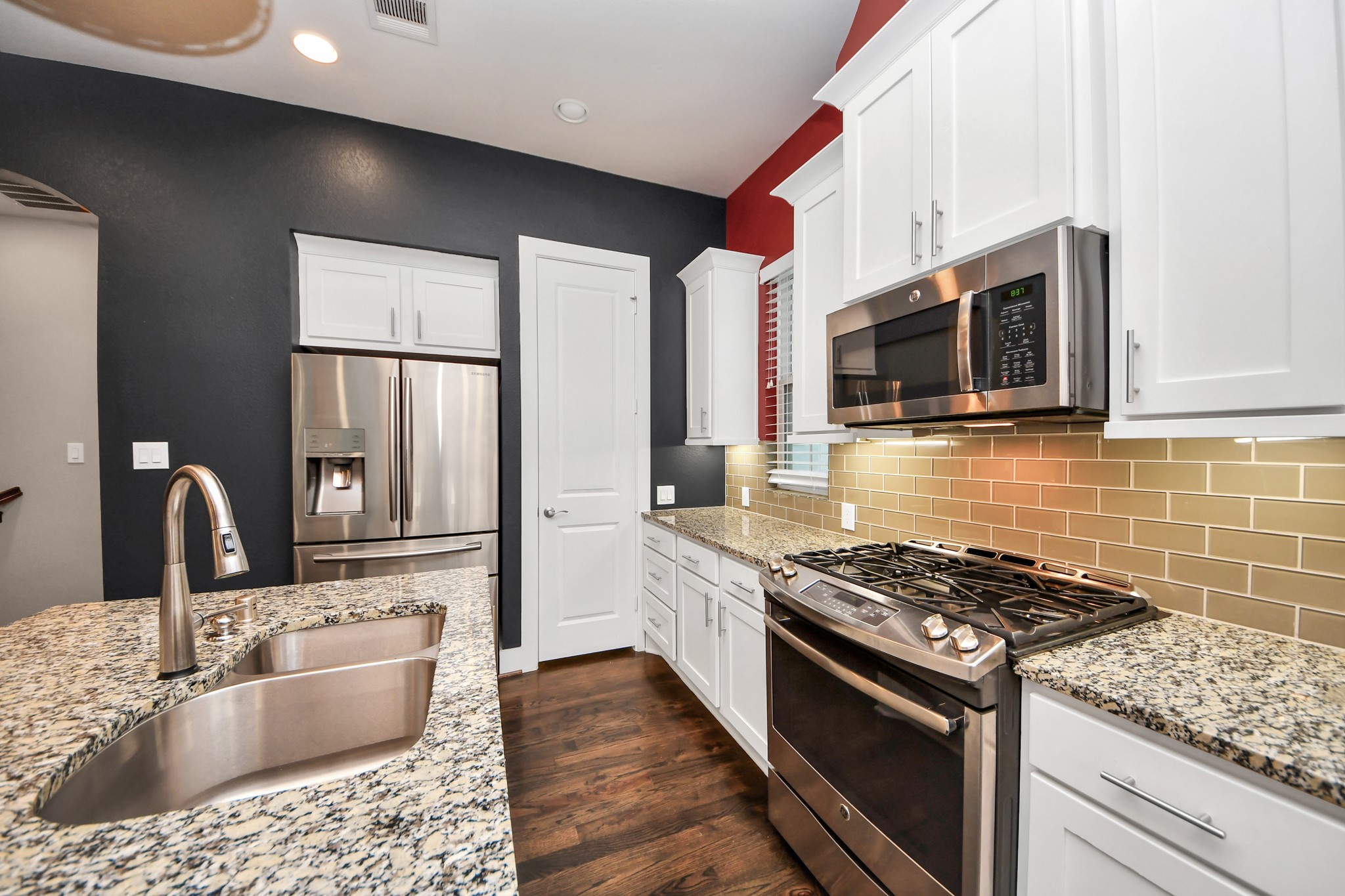 2704 Freund Street Houston, TX 77003 - Photo 18 of 45 a kitchen with stainless steel appliances granite countertop a sink stove and microwave