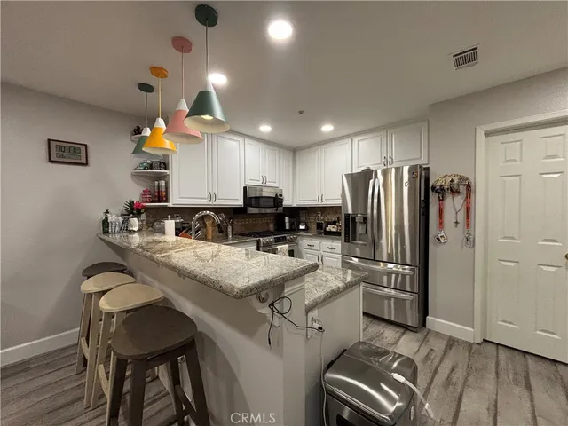 a view of a livingroom with furniture window and wooden floor