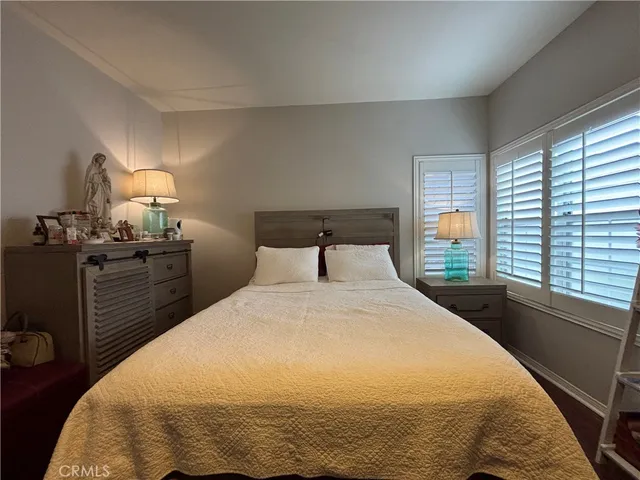 a bathroom with a granite countertop double vanity and a mirror