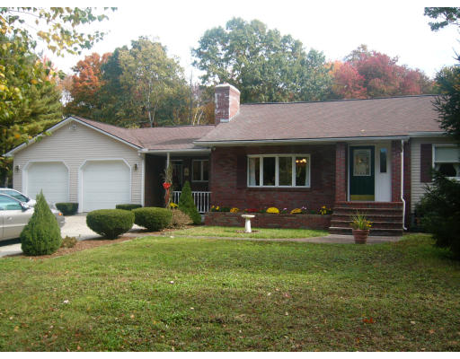414 Mountain Road Holyoke, MA 01040 - Photo 3 of 9 a front view of a house with garden and porch