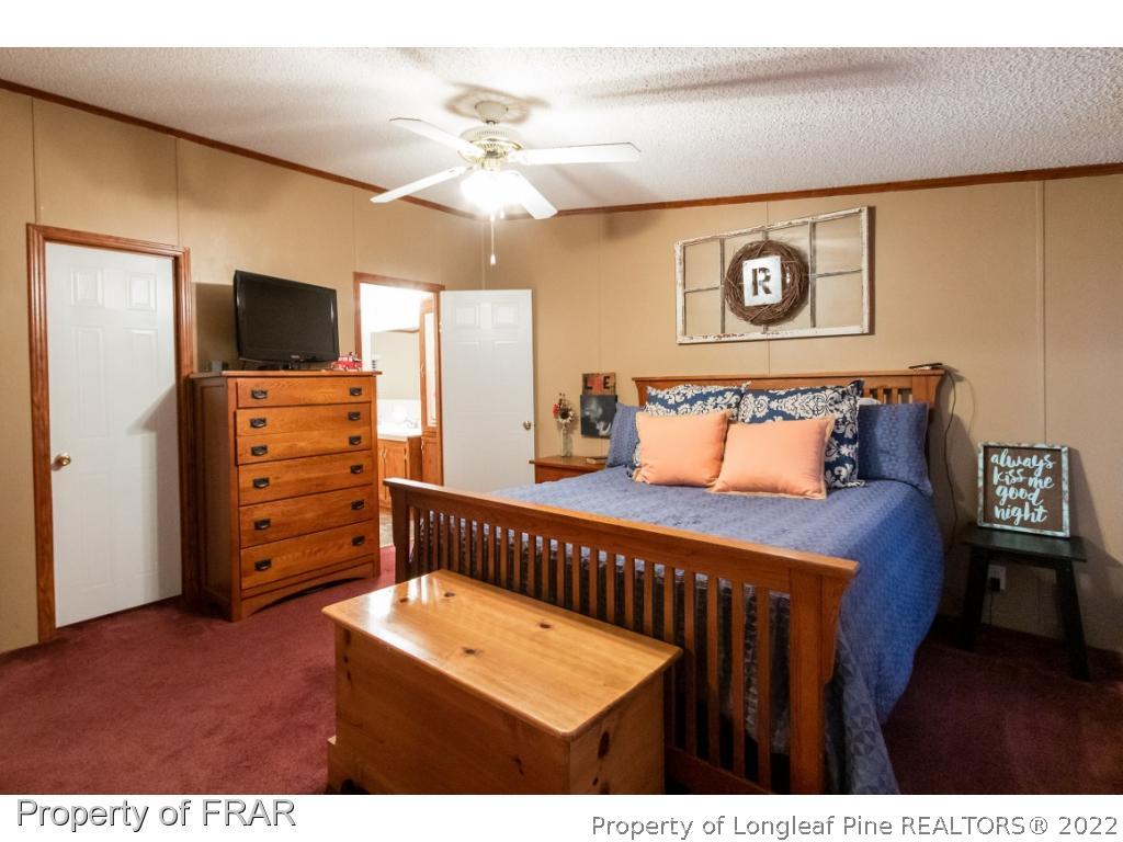 164 Sharp Lane Carthage, NC 28327 - Photo 5 of 28 a view of a bedroom with furniture and wooden floor