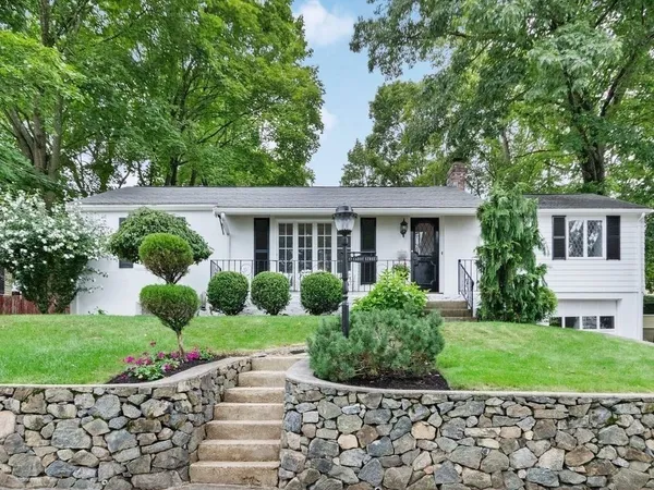 a front view of a house with garden